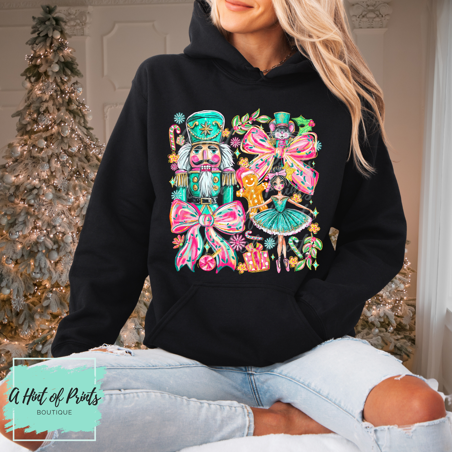 Person wearing a black hoodie with a colorful nutcracker design in a festive setting.